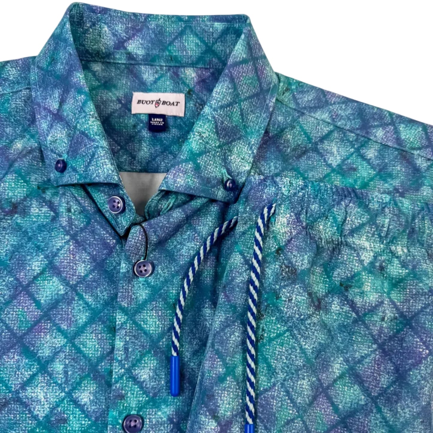 Blue patterned shirt and shorts with brand label on a white background