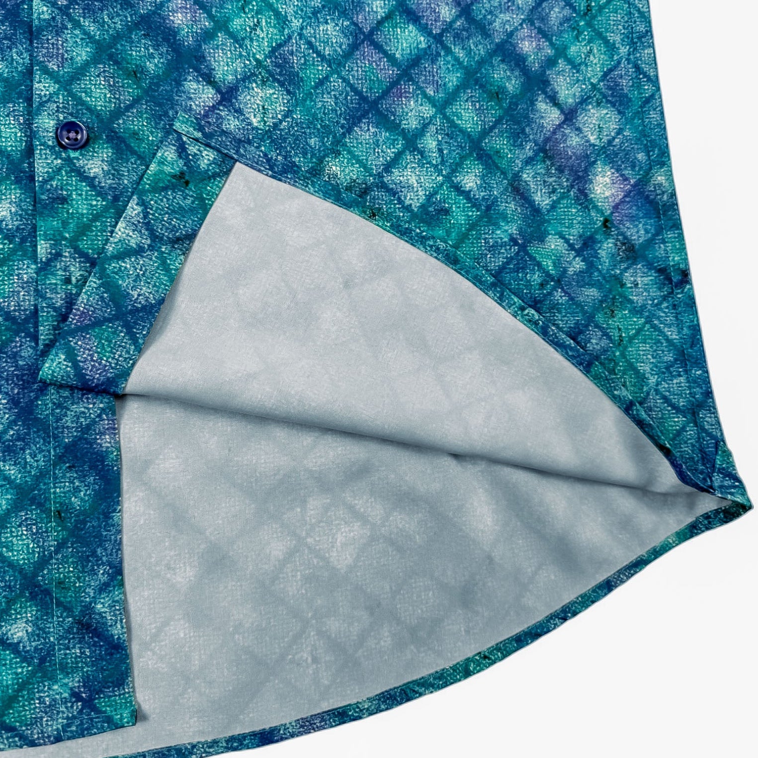Close-up of a blue patterned shirt with a light gray collar on a white background