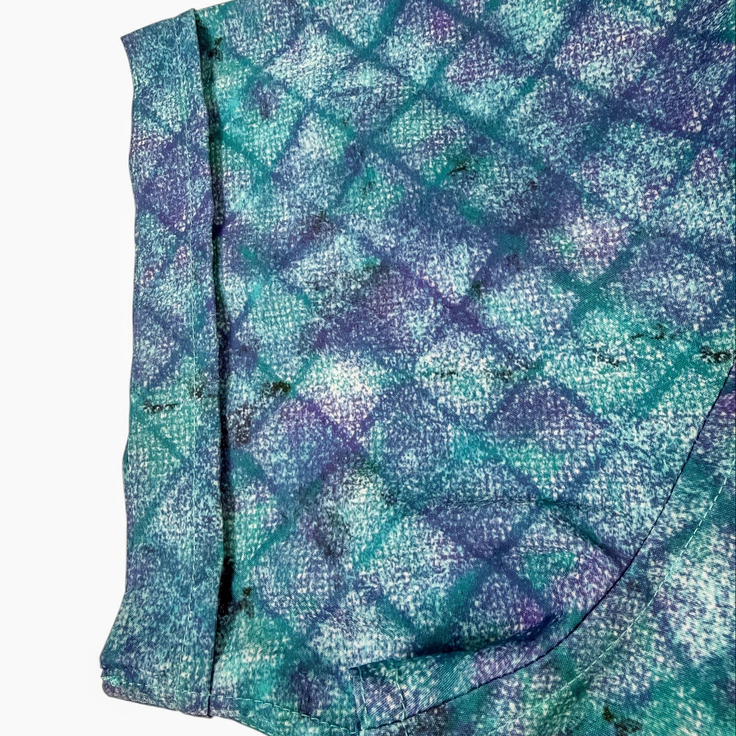 Shirt sleeve  with blue and green pattern on a white background