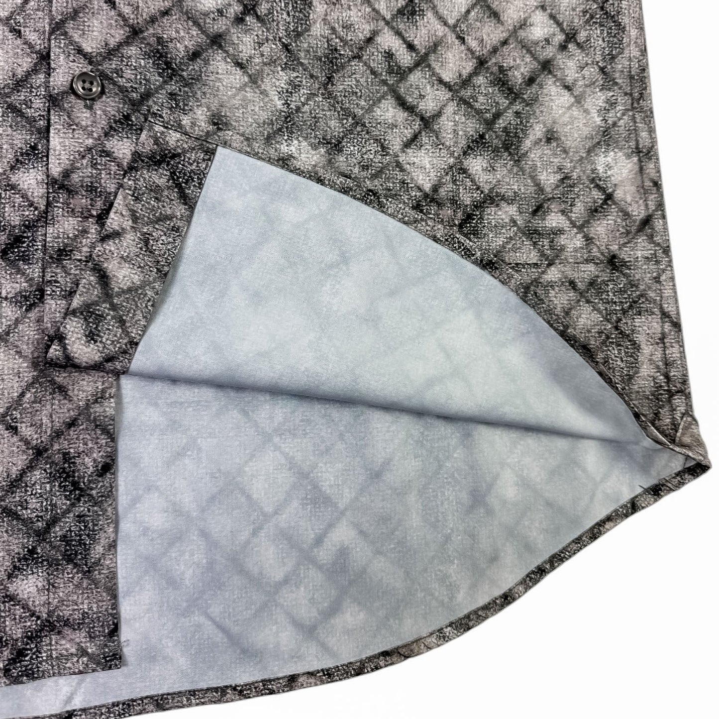 Close-up of a textured shirt  fabric with a geometric pattern on a white background