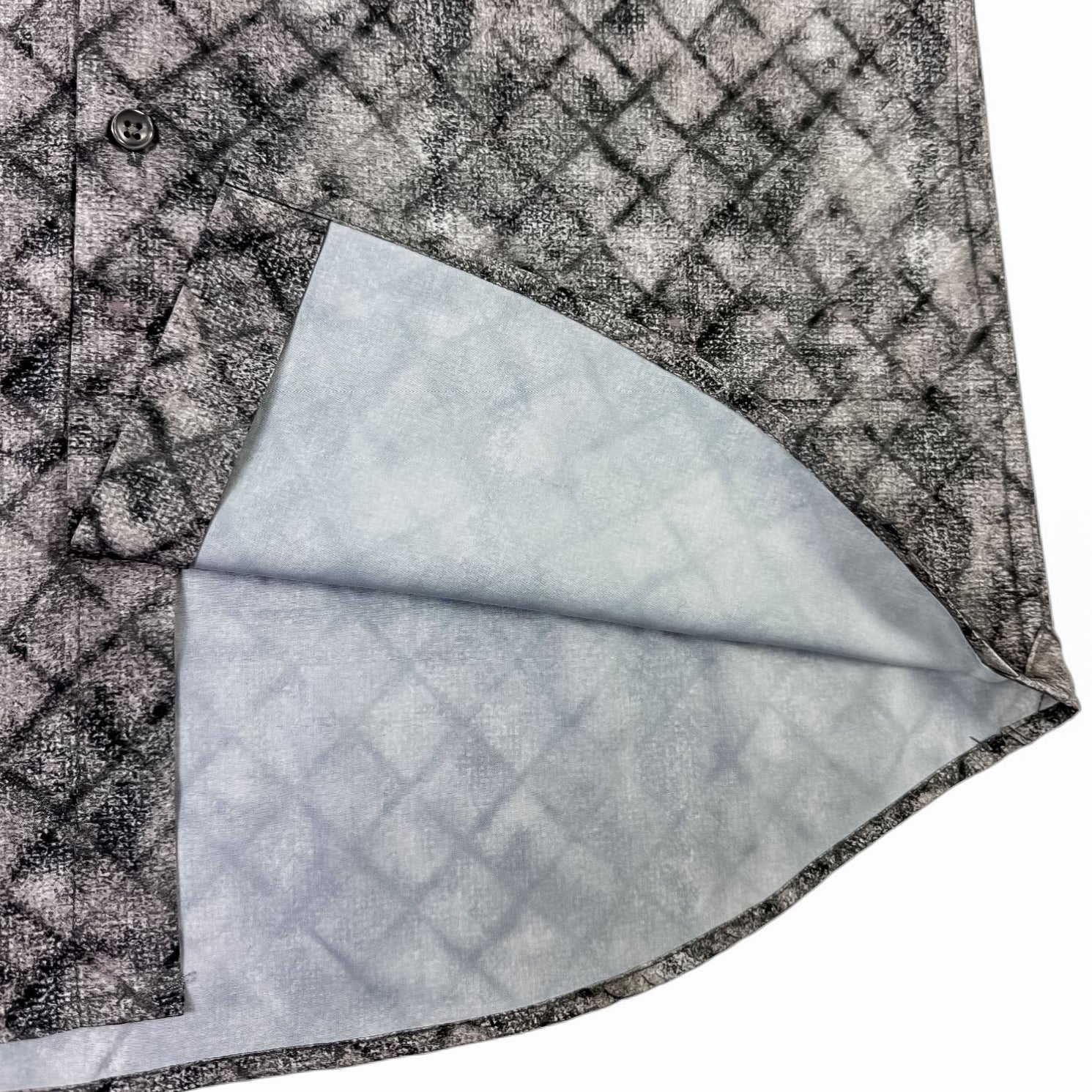 Close-up of a textured shirt  fabric with a geometric pattern on a white background