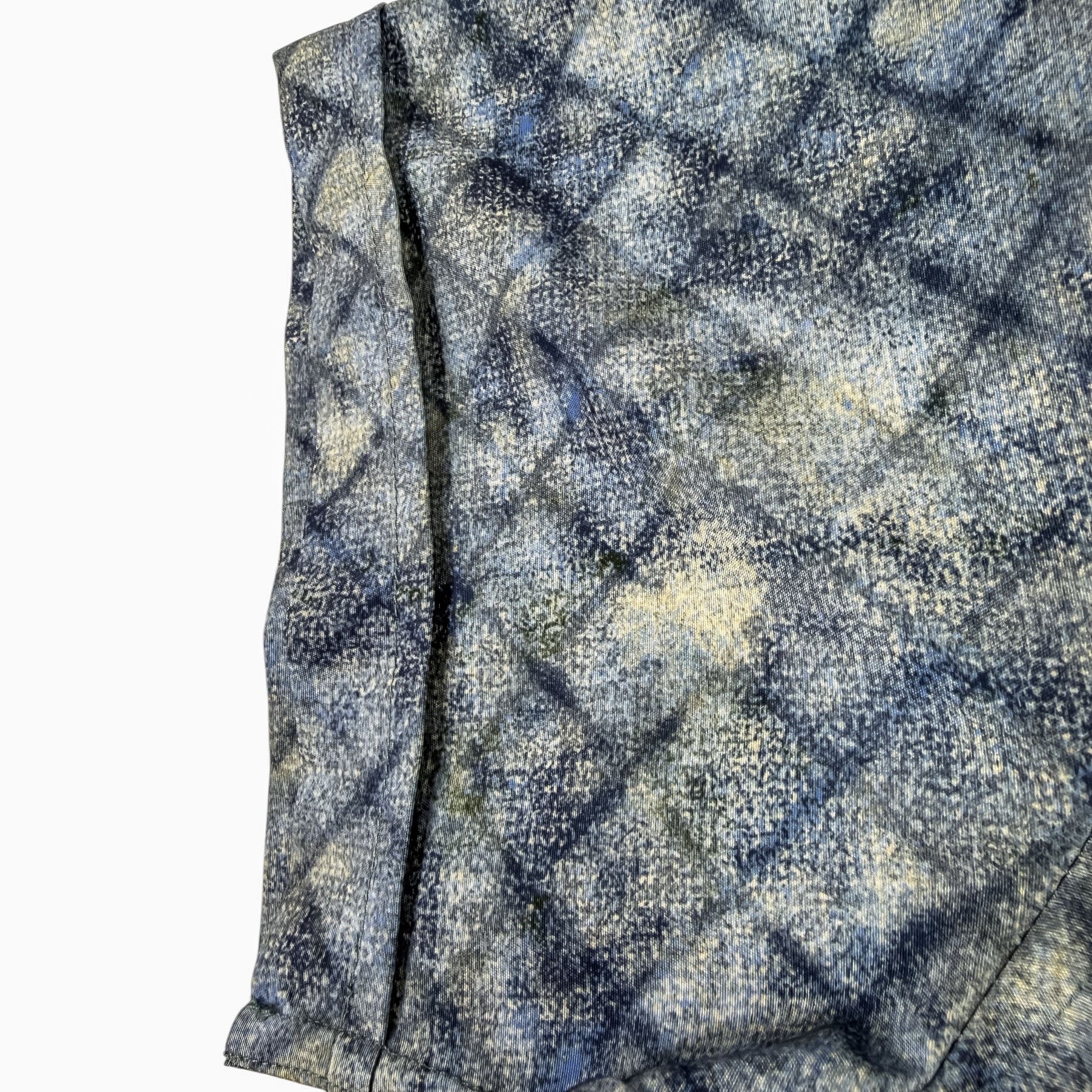 shirt sleeve with a blue and gray checkered pattern on a white background