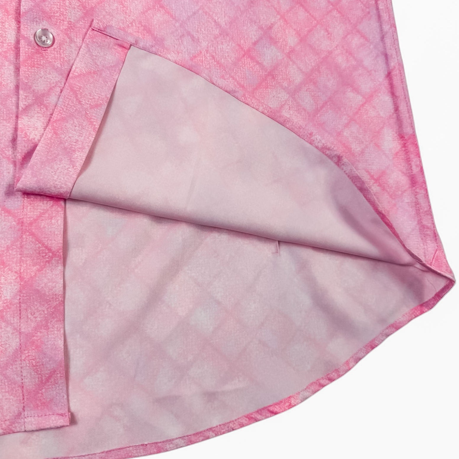 Close-up of a pink patterned shirt with a button and collar detail on a white background