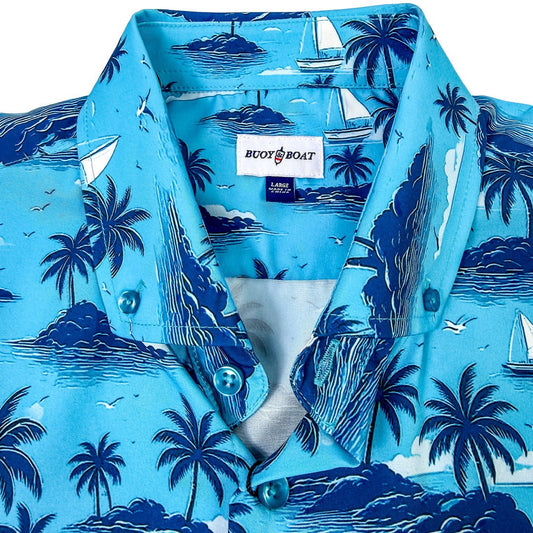 Blue shirt with tropical island and sailboat pattern, featuring a visible brand label.