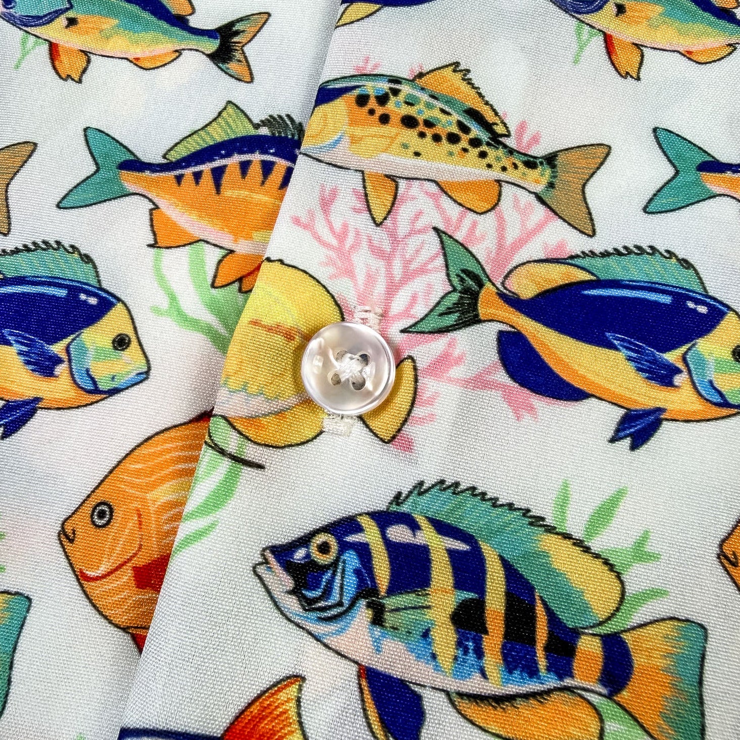 shirt with colorful fish pattern on a white background
