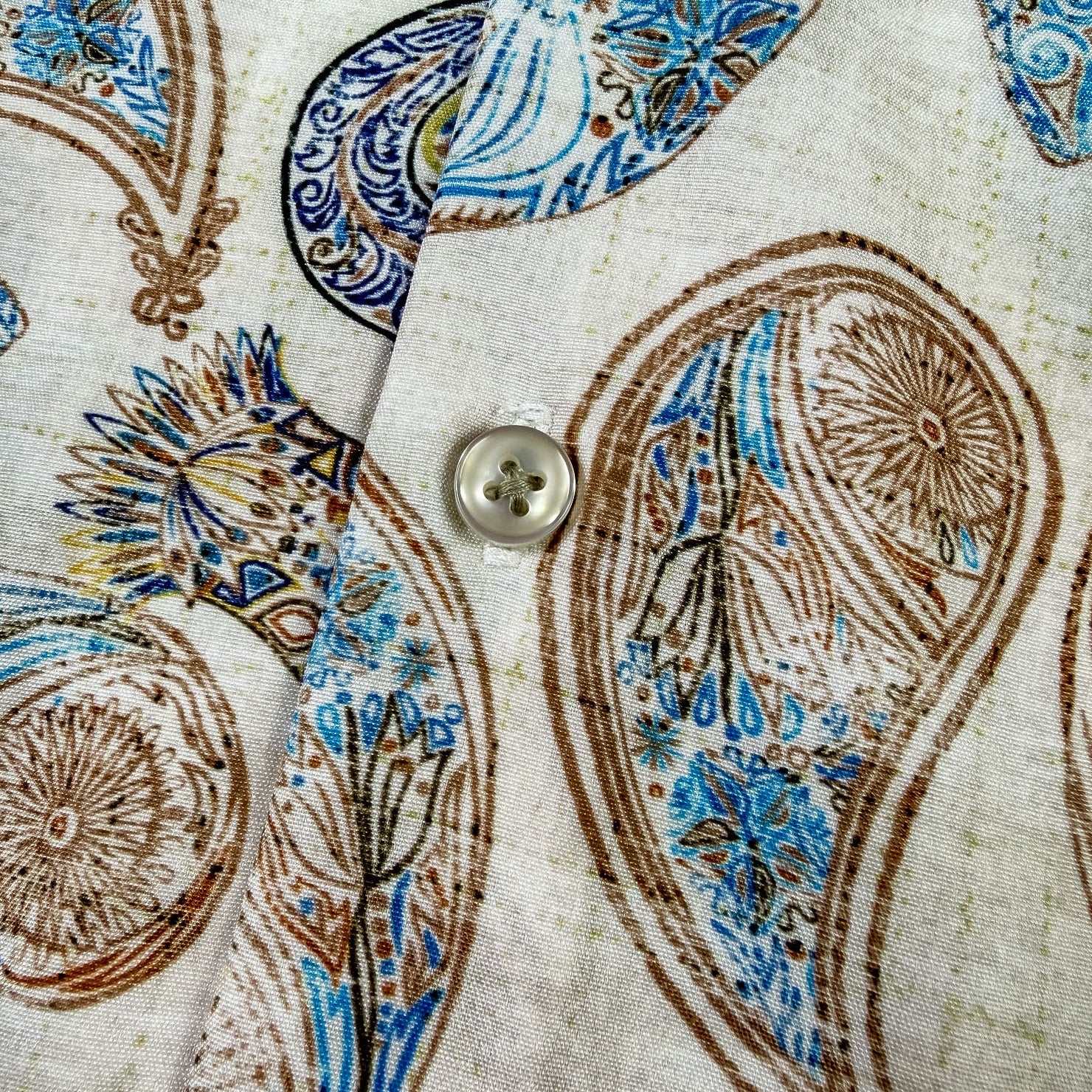 Close-up of a shirt with paisley pattern and button