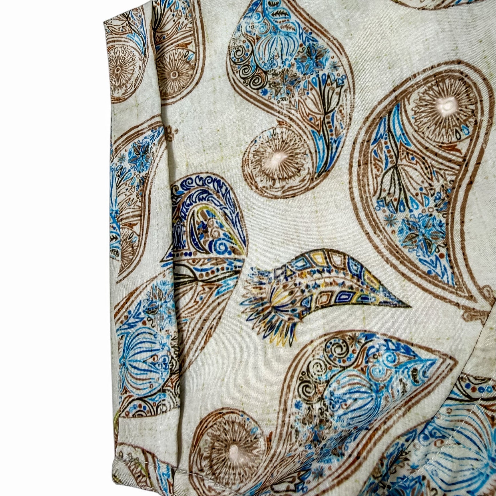 Shirt Sleeve with intricate paisley pattern in blue and brown on a beige background