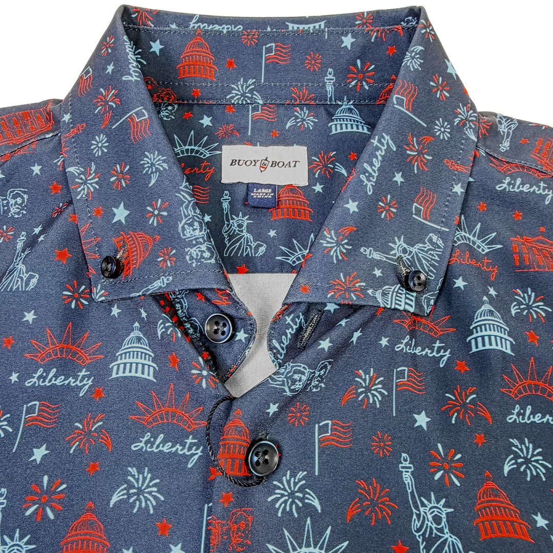 Close-up of a blue shirt with red and white pattern featuring American symbols.