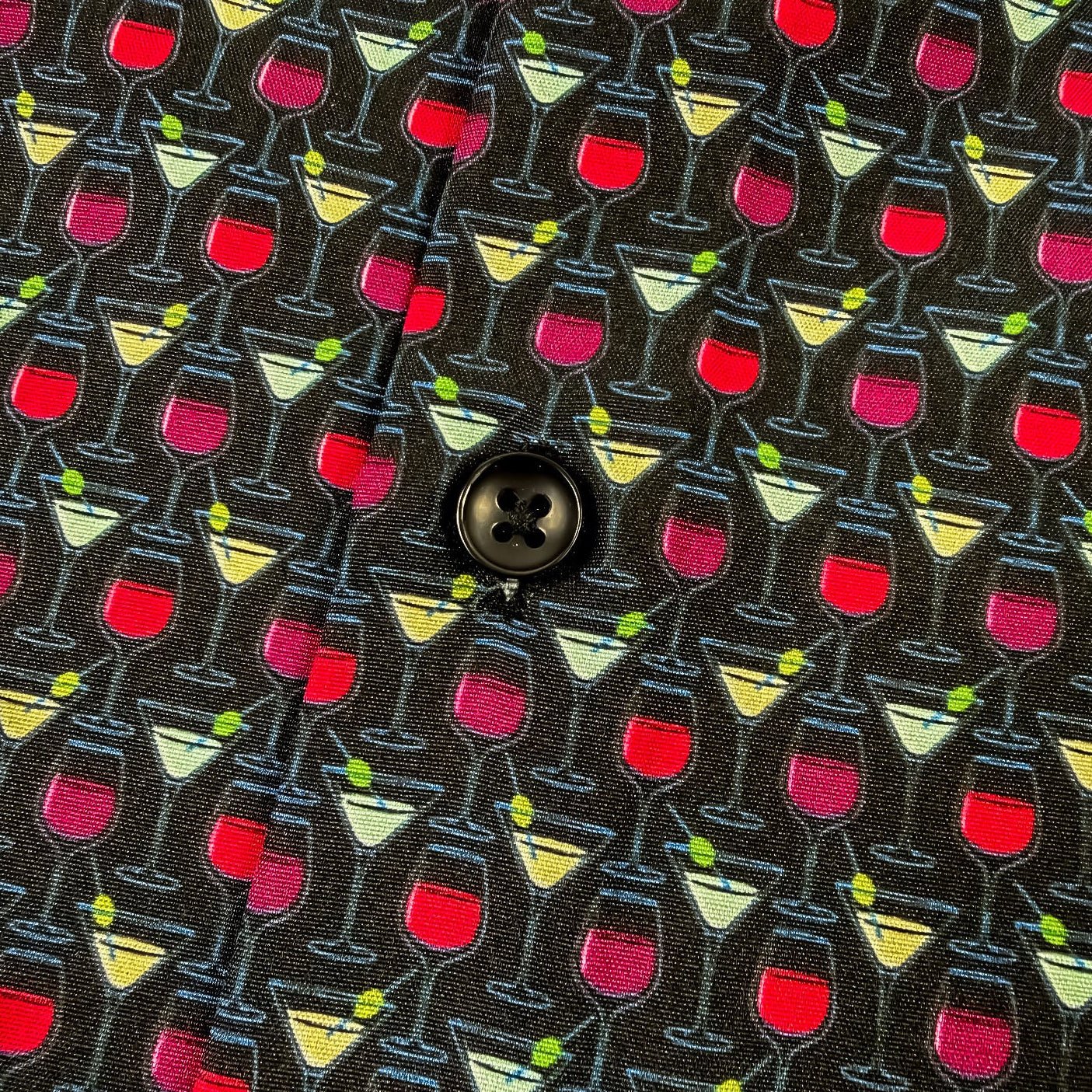 Patterned fabric with cocktail glass design on a black background