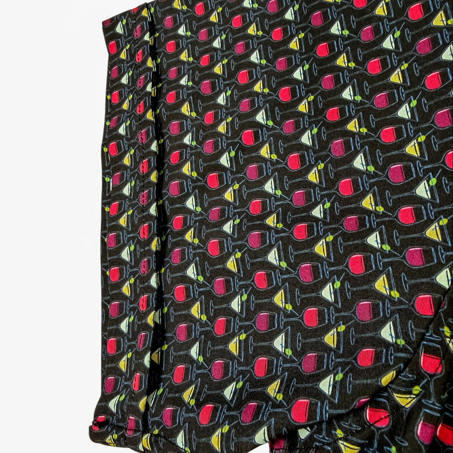 Shirt sleeve with a pattern of wine glasses on a black background