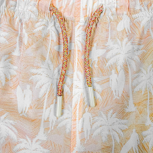 Close-up of colorful strings with white tips on a patterned fabric background