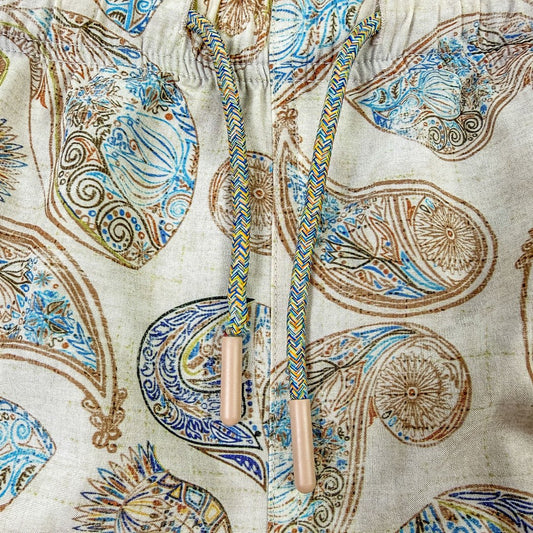 Decorative shoelace with intricate patterns on a fabric background