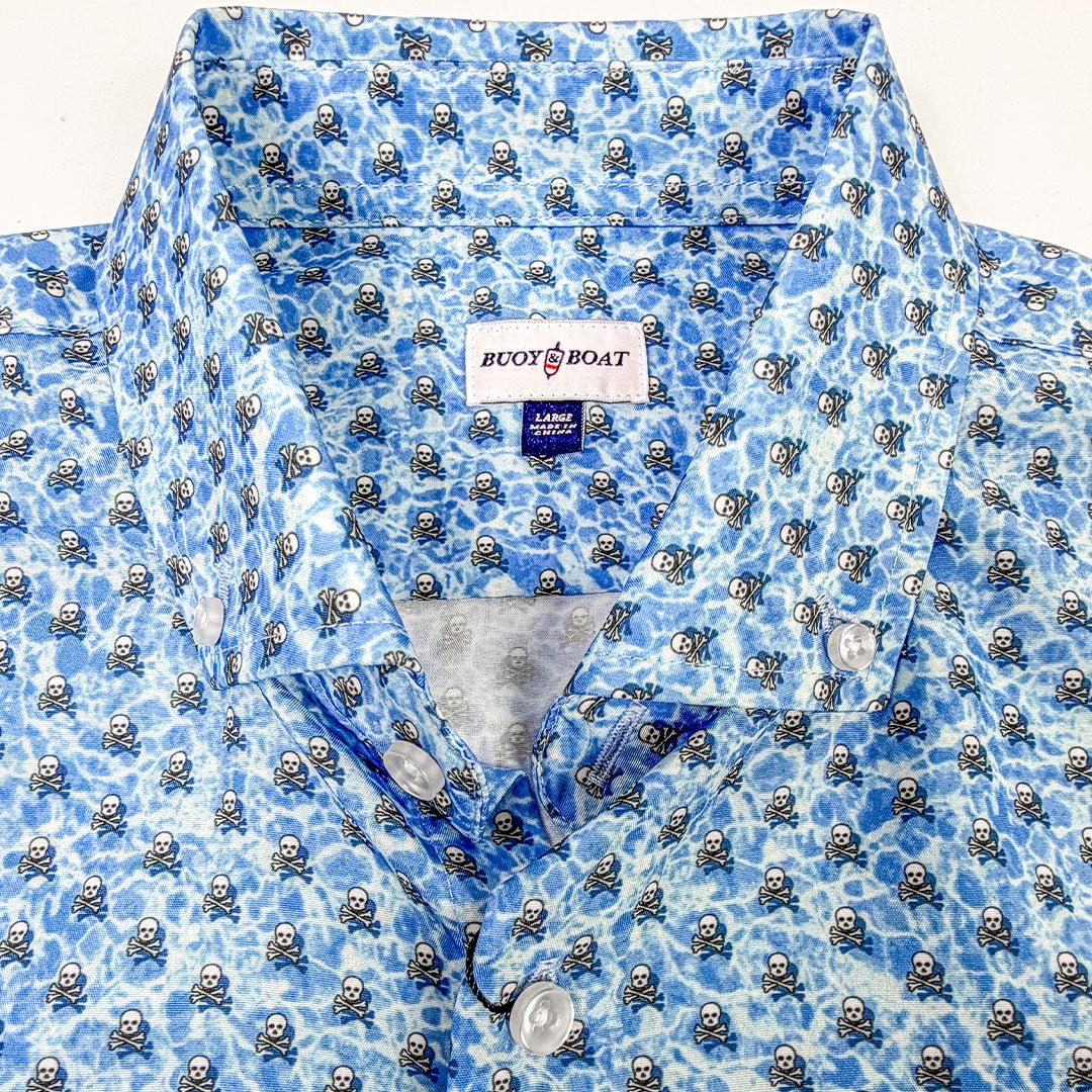 Blue patterned shirt with a visible brand label on a white background