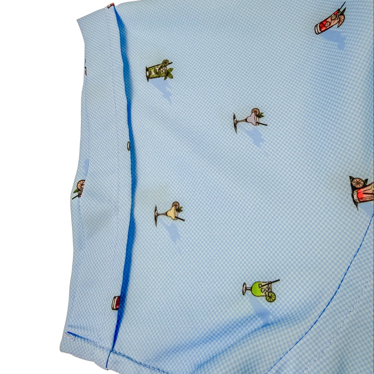 Light blue shirt sleeve with small cocktail glass graphics on a white background