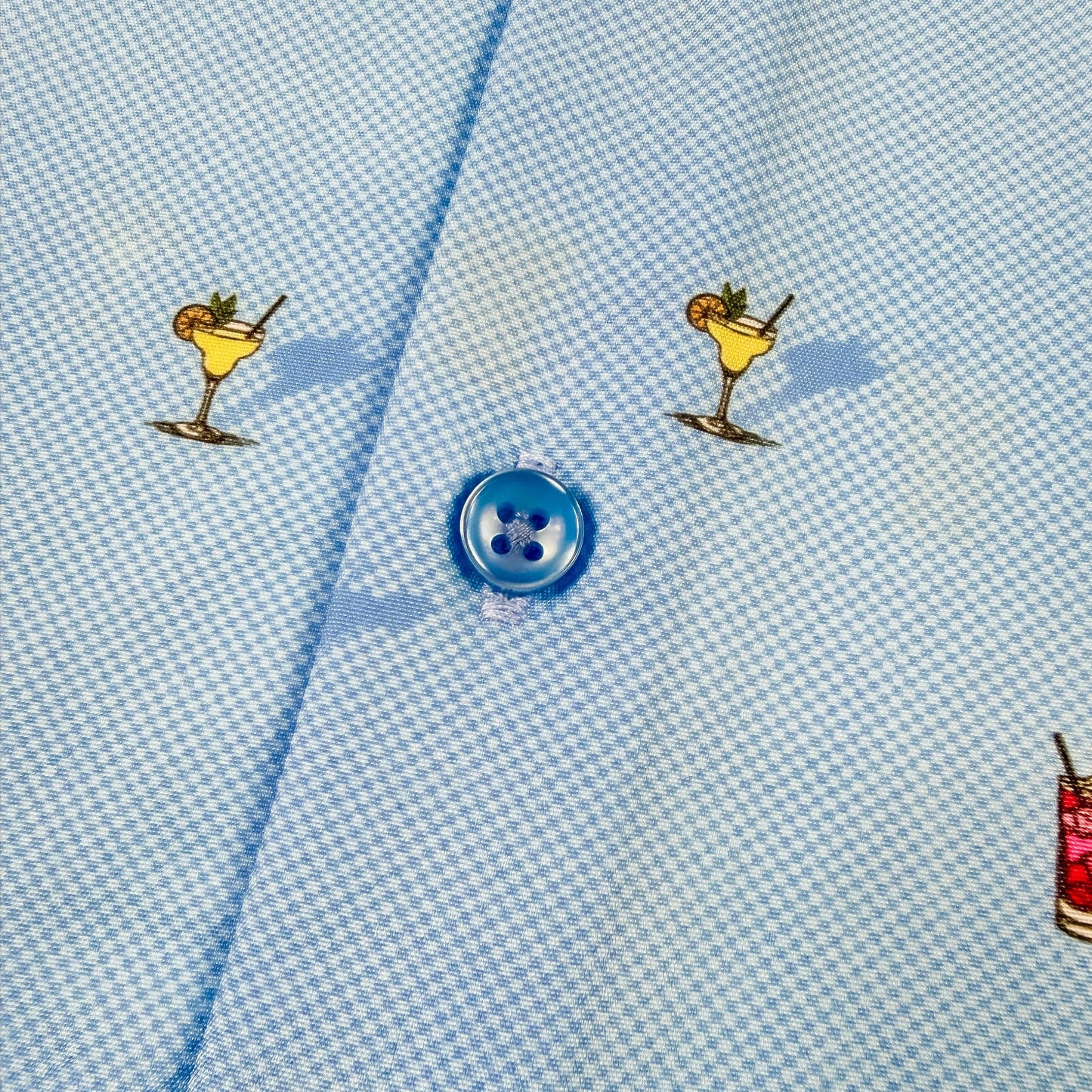 Light blue shirt fabric with colorful cocktail illustrations
