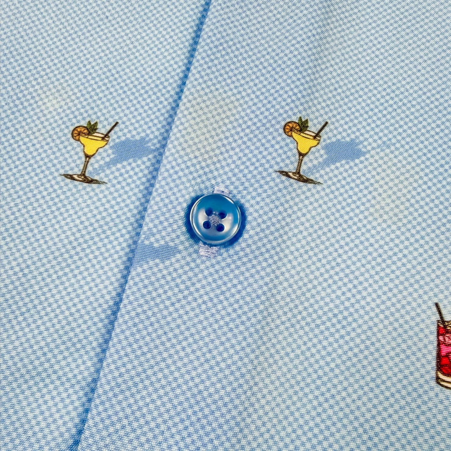 Light blue shirt fabric with colorful cocktail illustrations