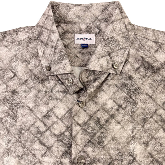 Patterned shirt with a visible brand label on a beige background