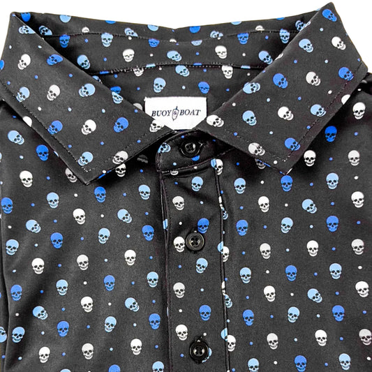 Folded black polo shirt with blue skull pattern on a white background