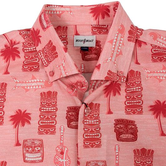 Pink shirt with red tiki mask and palm tree pattern on a white background