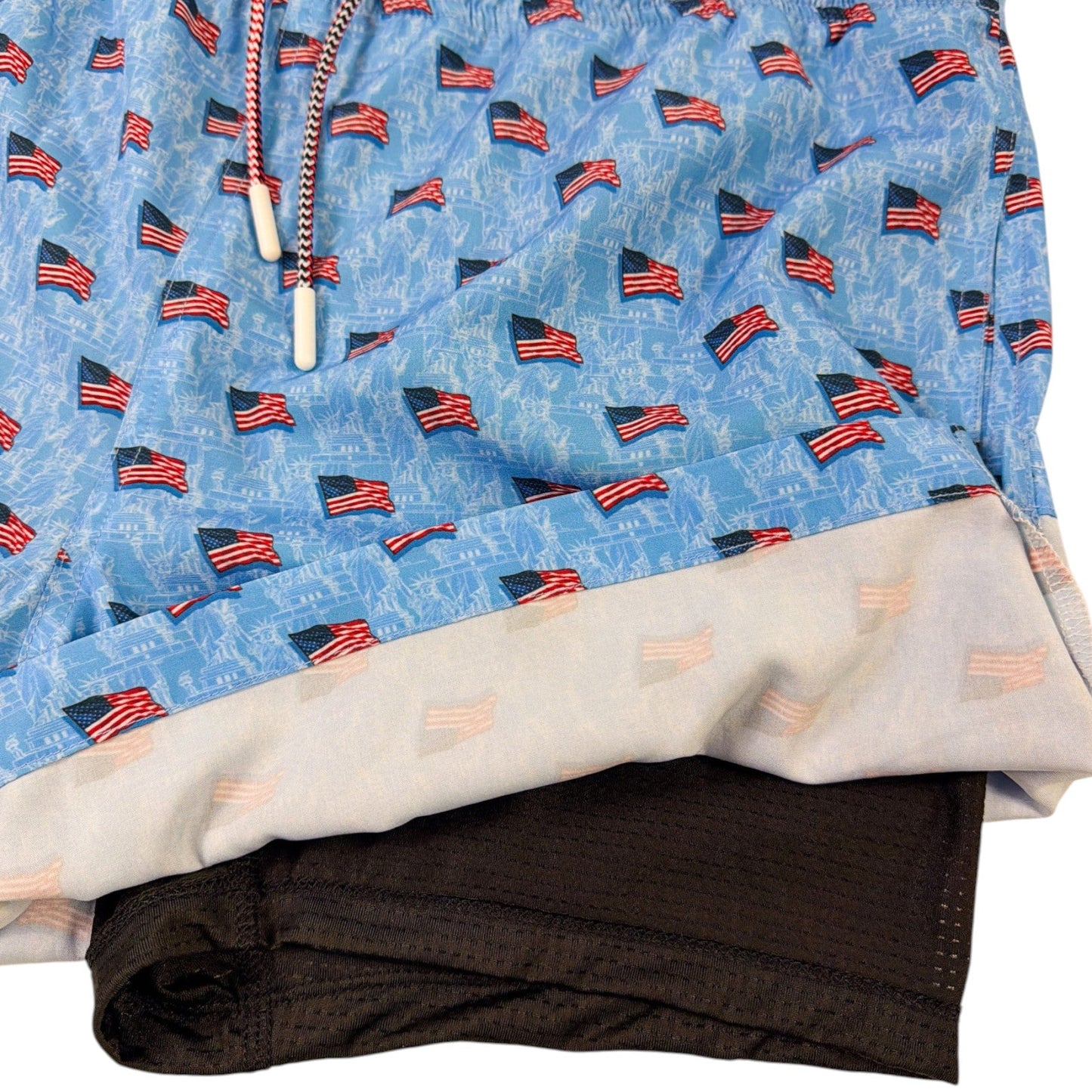 Folded shorts with American flag pattern on a white background